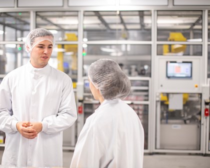 Deux employés discutant ensemble dans un bâtiment de production