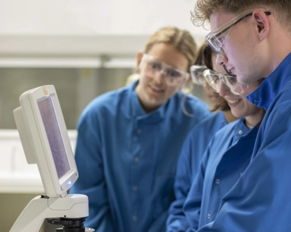 Quatre scientifiques travaillant avec un microscope